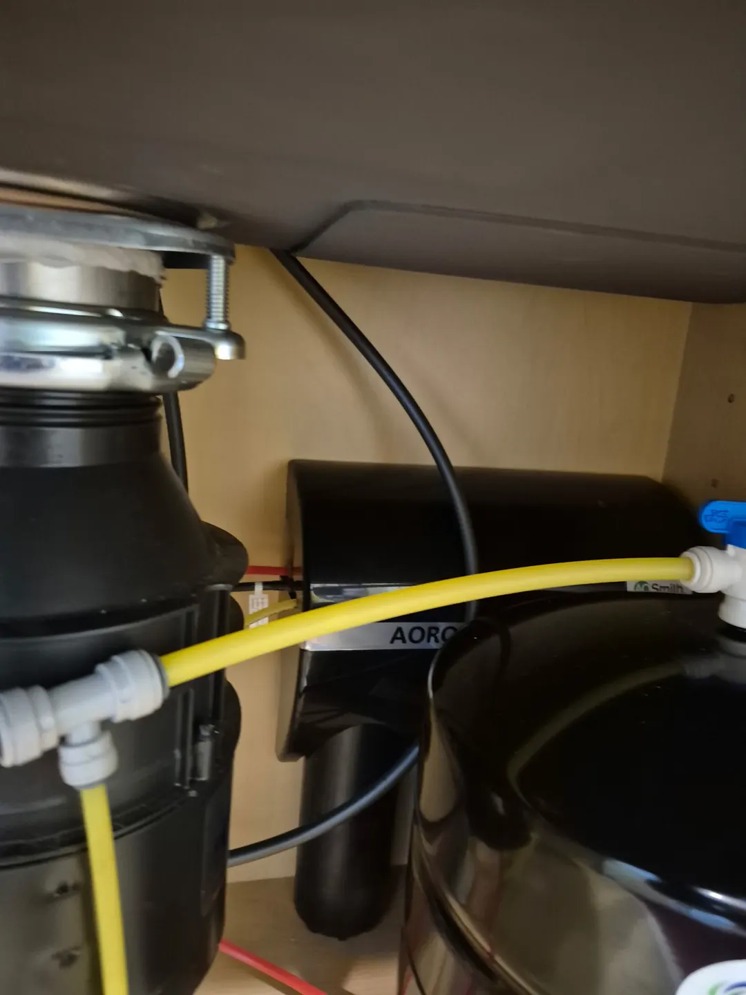 A.O. Smith under-sink reverse osmosis unit beside a garbage disposal