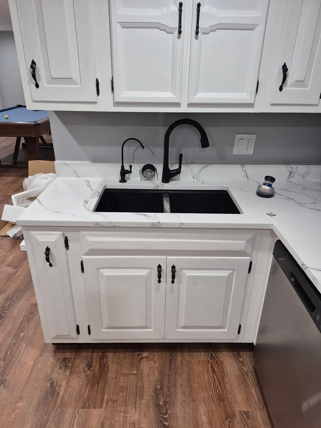 Finished kitchen with a black drinking water faucet next to the main faucet
