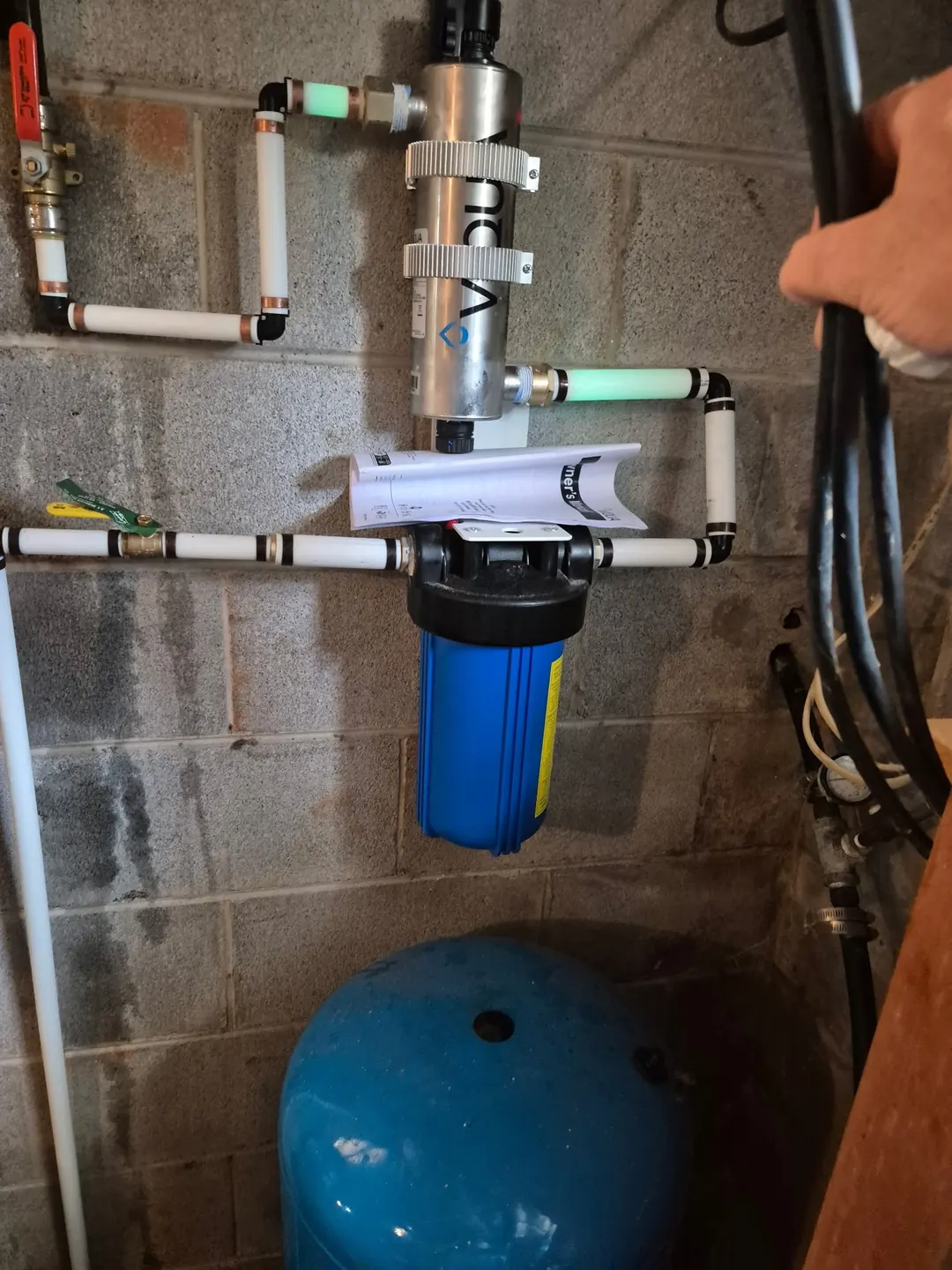 UV unit and large cartridge filter mounted above a well pressure tank